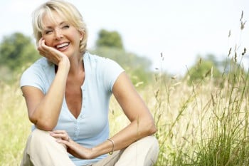 Portrait of mature woman sitting in countryside celebrating retirement
