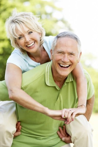 Mature couple having fun in countryside celebrating retirement