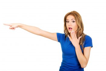 Young female college student pointing at headline