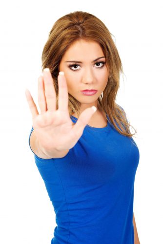 Female college student holding up her hand to signal stop