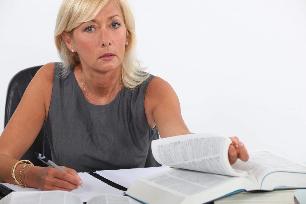 attractive female attorney referencing law book