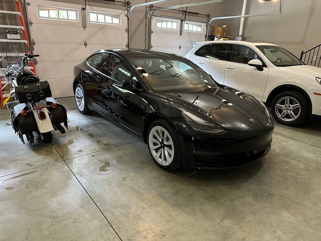 Tesla at home between Harley and Porsche